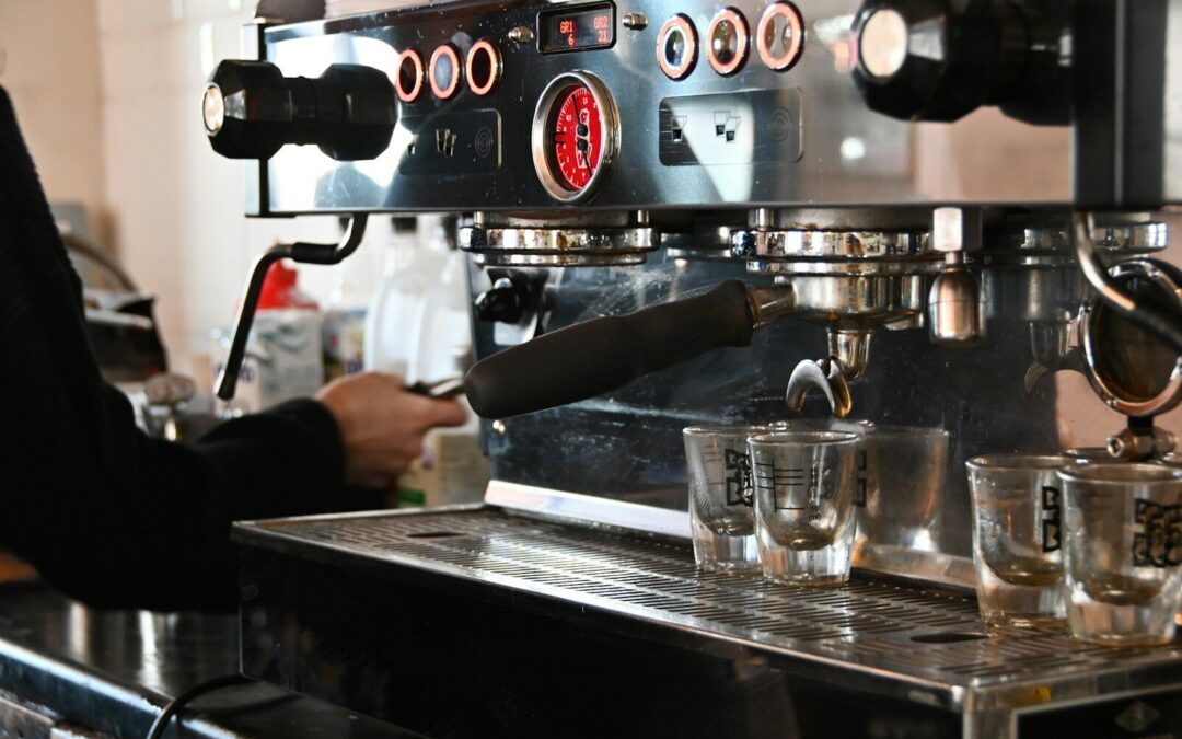 a person pouring a drink into a glass